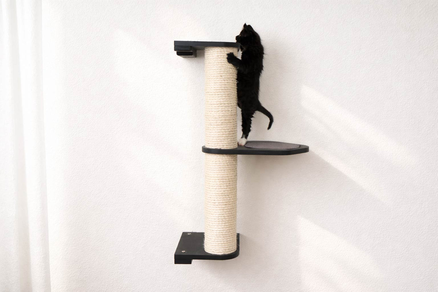 Wall mounted sisal cat scratching pole with a leaf shelf attached partway up