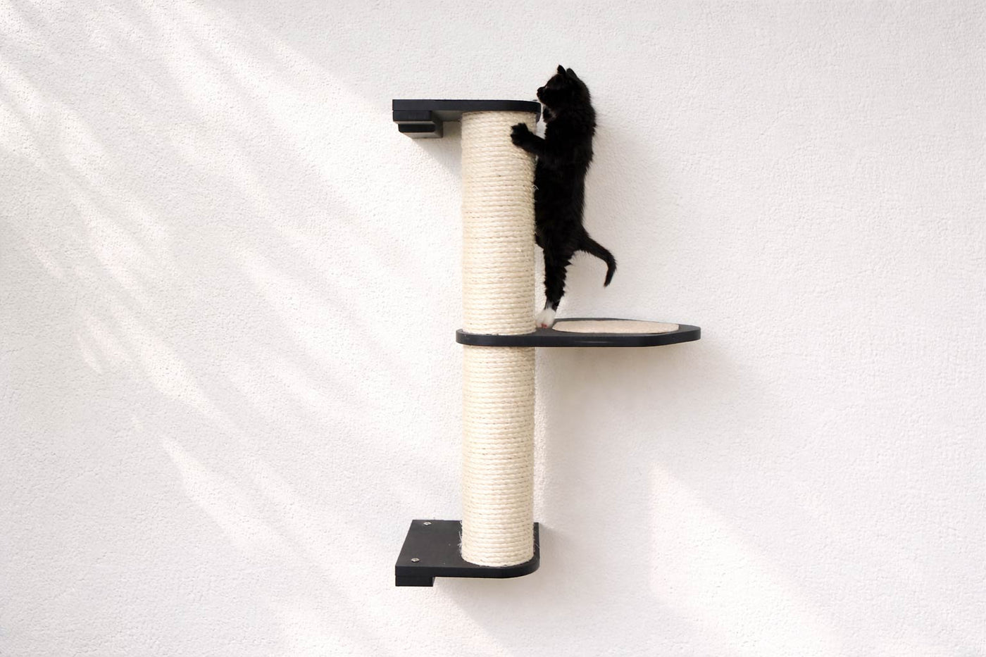 Wall mounted sisal cat scratching pole with a leaf shelf attached partway up