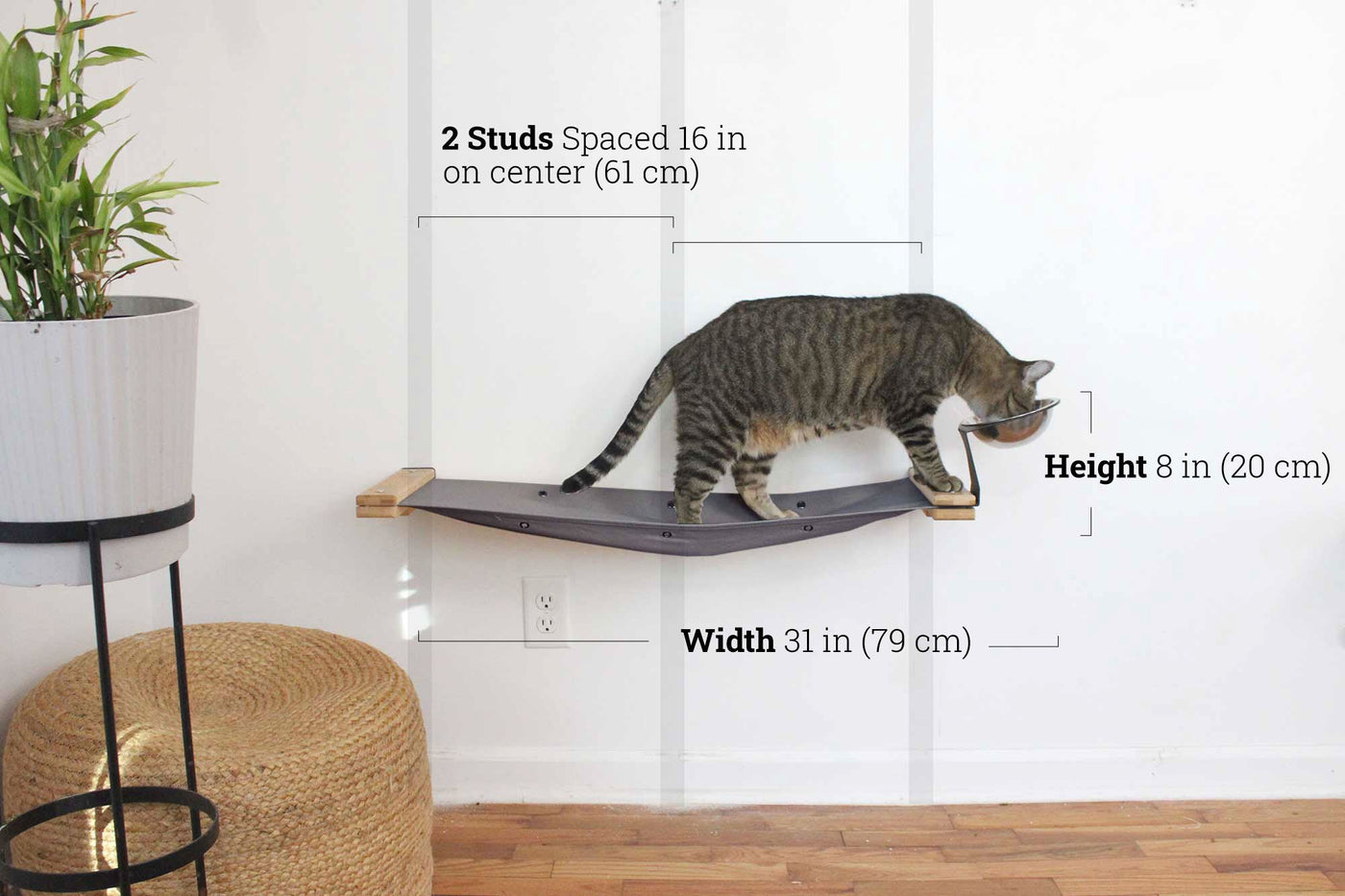 Wall mounted raised cat feeder with food dishes and an attached canvas lounge