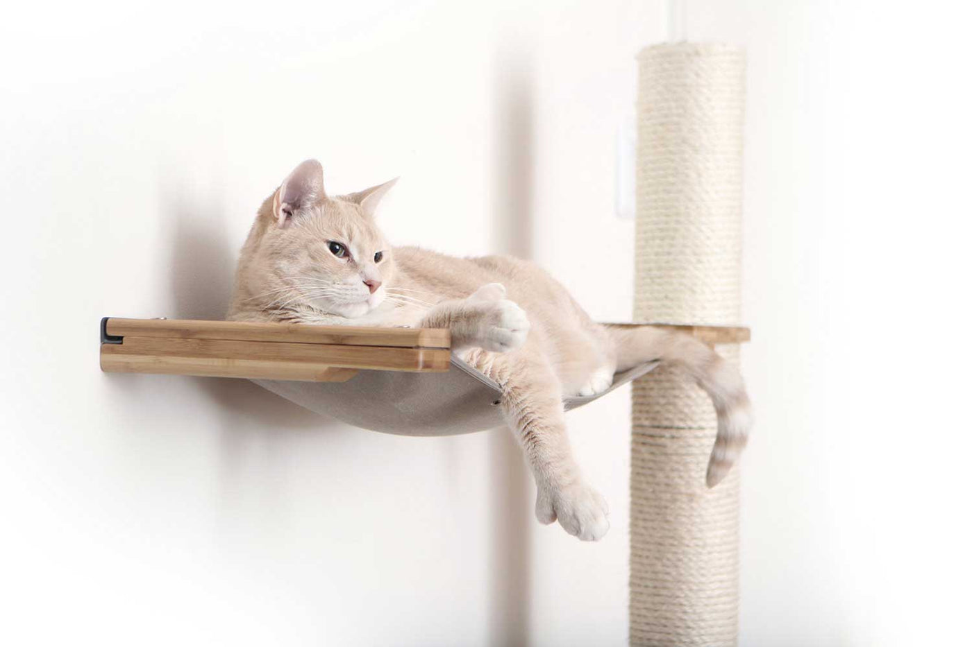 Tall wall mounted cat scratcher tree with a sisal pole installed high near the ceiling