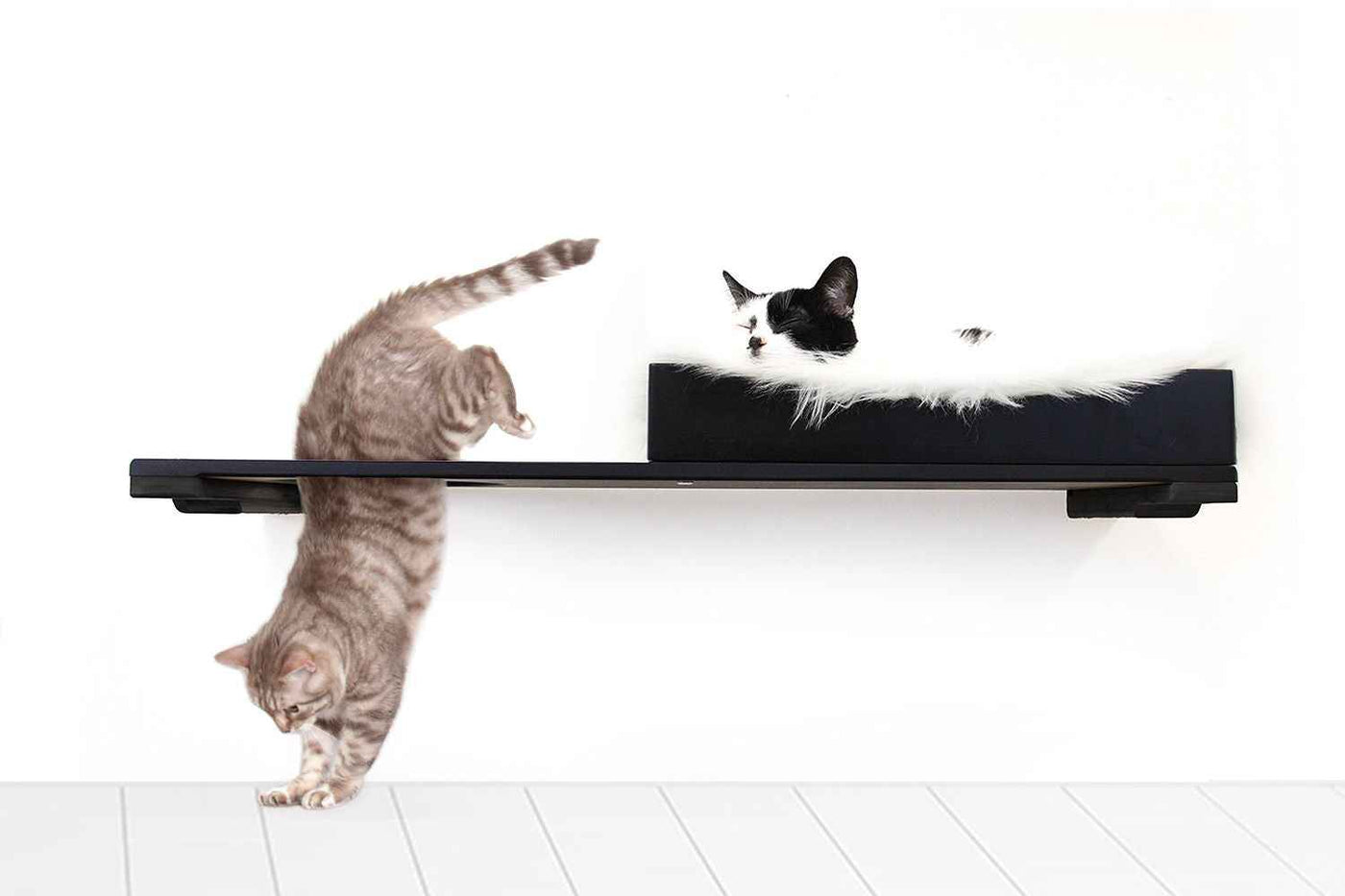 Wall-mounted bamboo cat bed with a curved front ledge and faux fur pad