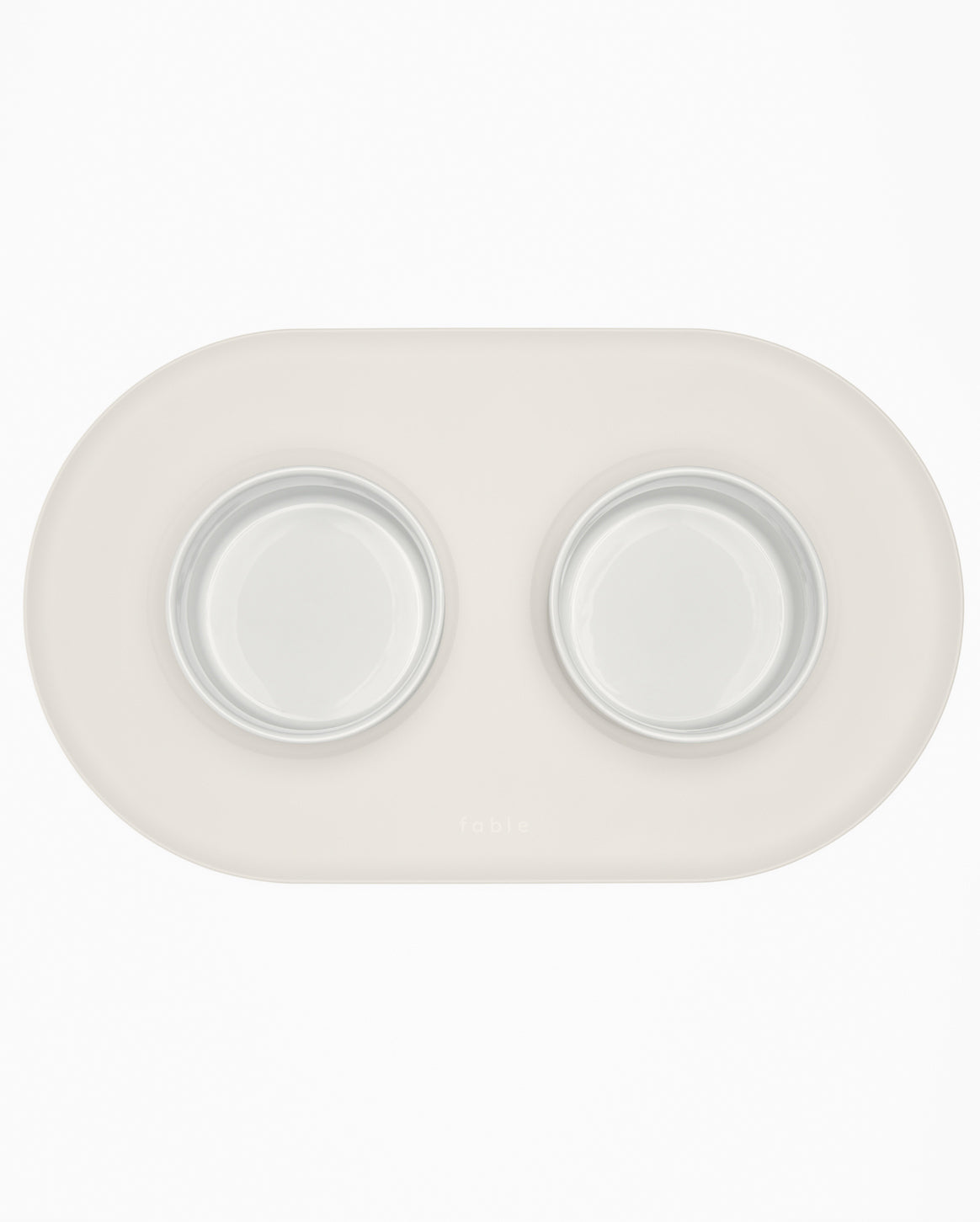 Fable Signature Bowl Mat with a raised border under a cat bowl