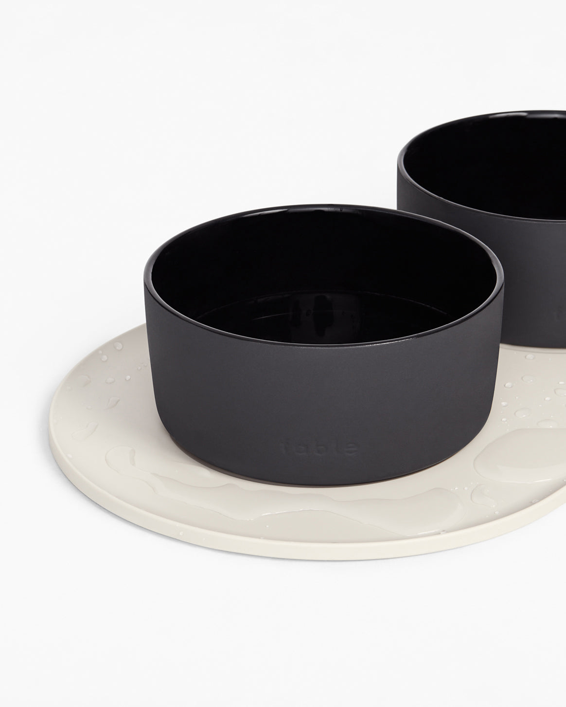 Fable Signature Bowl Mat with a raised border under a cat bowl
