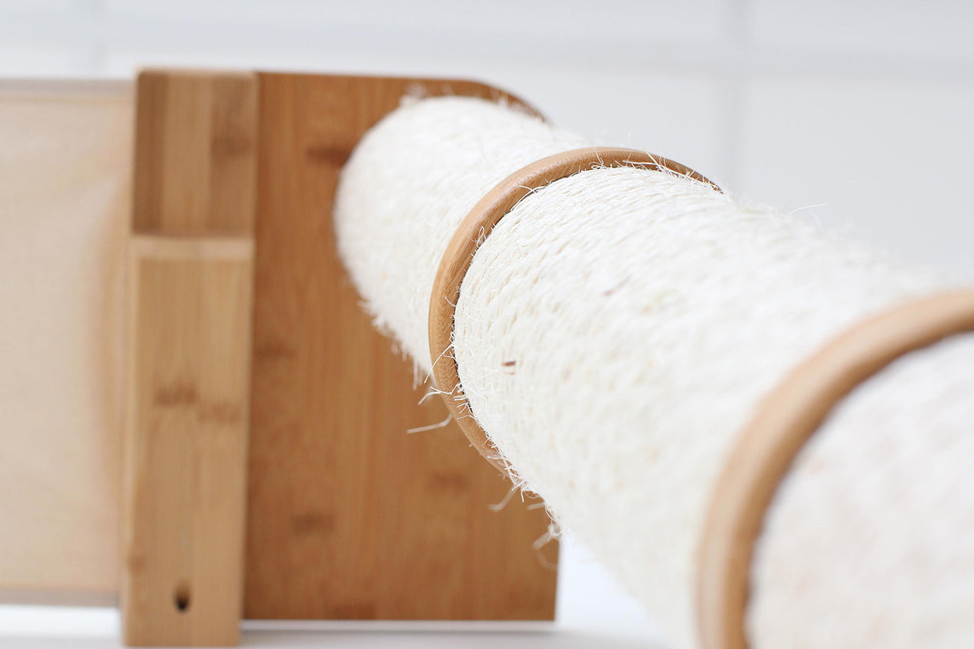 Wall mounted cat condo with a tall three-tier sisal scratching pole and stacked platforms
