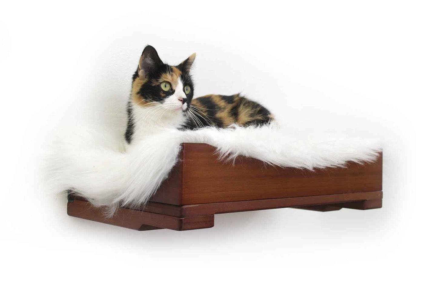 Wall-mounted bamboo cat bed with a curved front ledge and faux fur pad