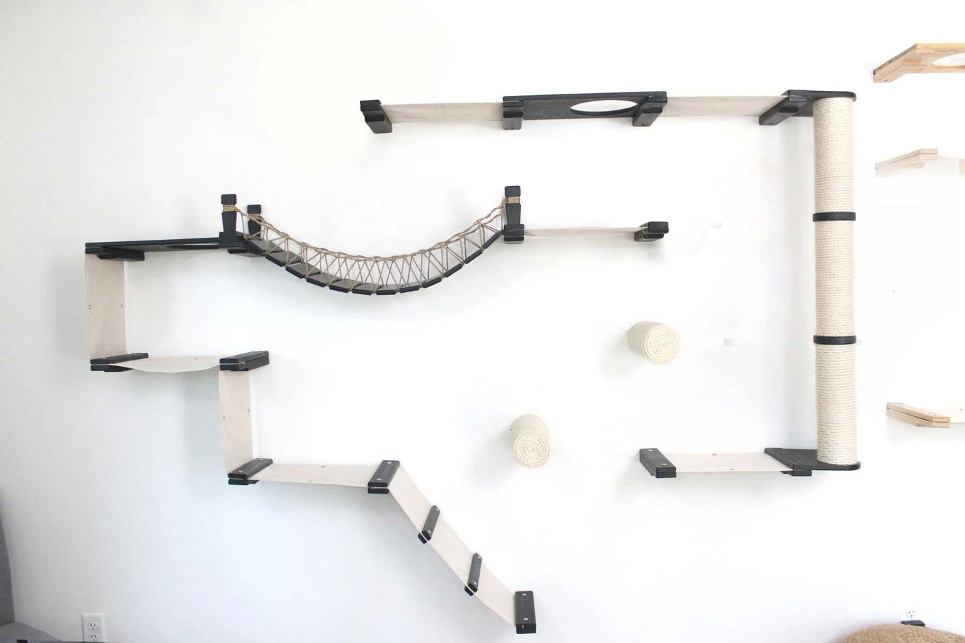Large wall mounted cat condo packed with hammocks, a sisal pole, floating posts, a bridge, and a planter shelf