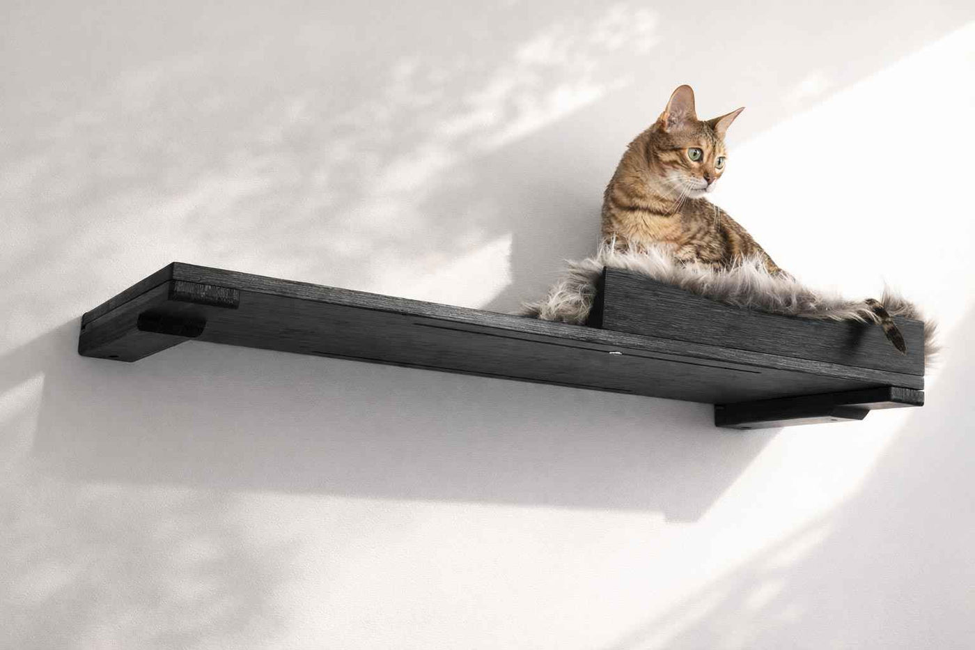 Wall-mounted bamboo cat bed with a curved front ledge and faux fur pad