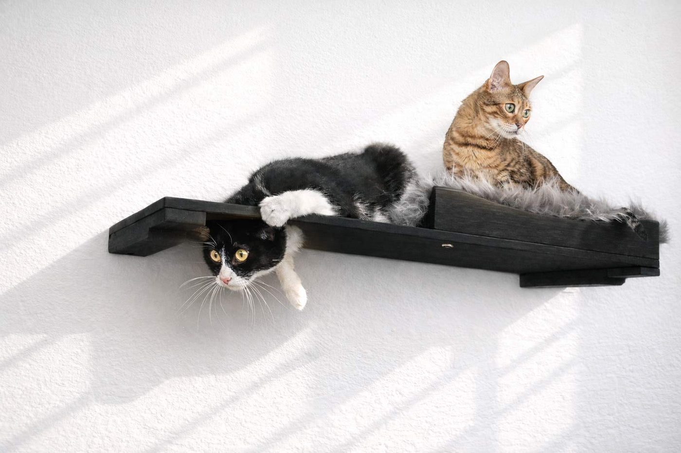Wall-mounted bamboo cat bed with a curved front ledge and faux fur pad