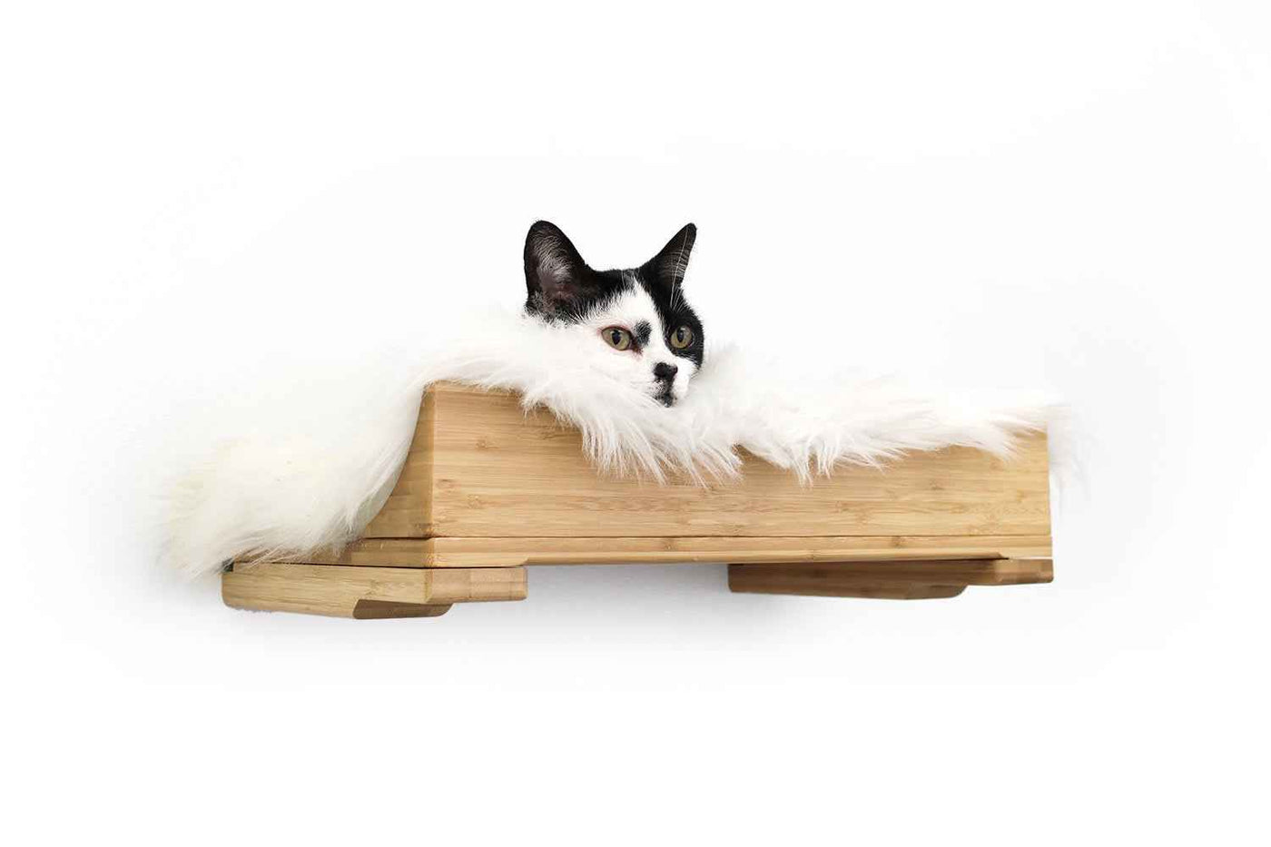 Wall-mounted bamboo cat bed with a curved front ledge and faux fur pad