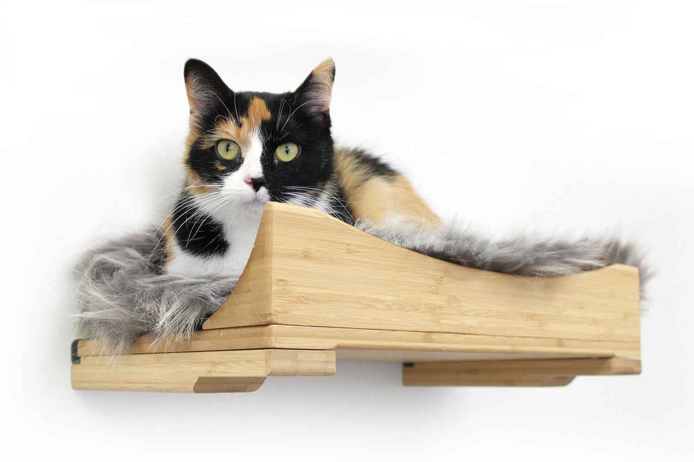 Wall-mounted bamboo cat bed with a curved front ledge and faux fur pad